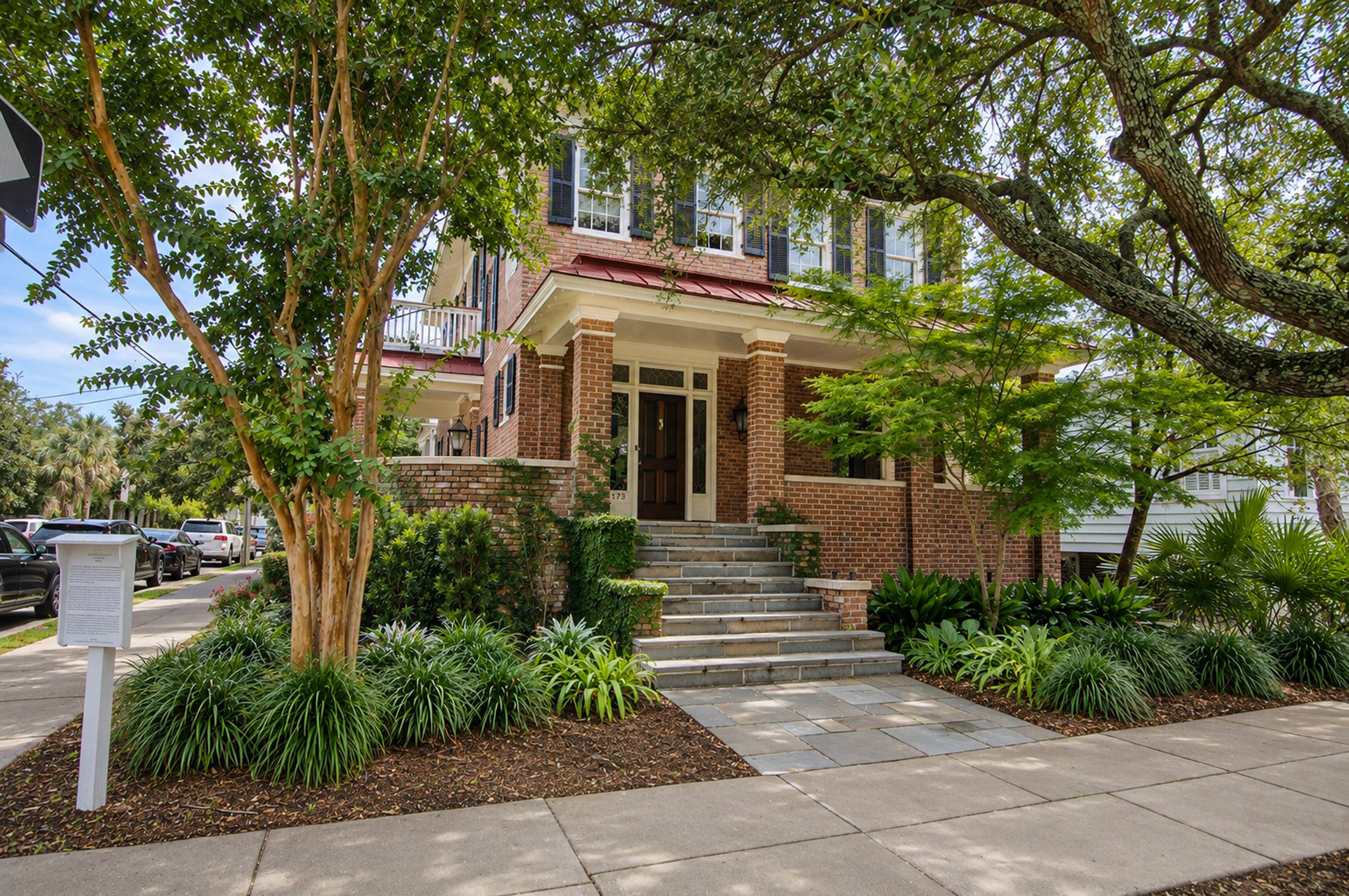 Front approach and shaded porch at 173 Tradd Street
